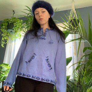 Blue alpaca sweater with tribal print and lace-up detailing